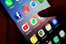 Icons of social media apps are displayed on a mobile phone screen. PIC: Yui Mok/PA Wire